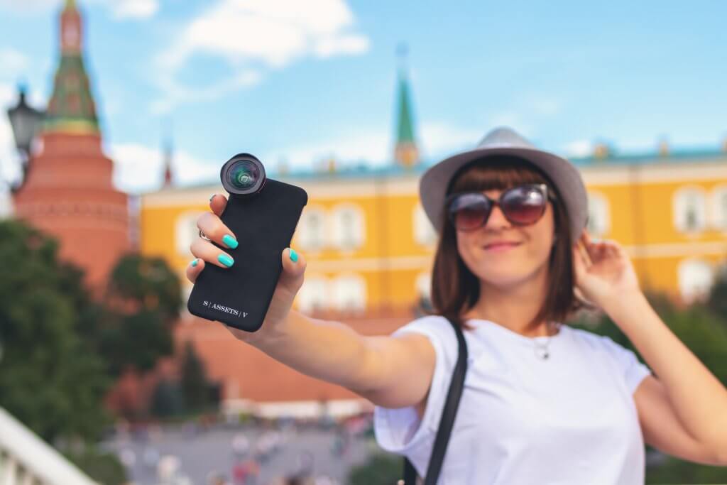 hat wearing woman taking a selfie while on vacation