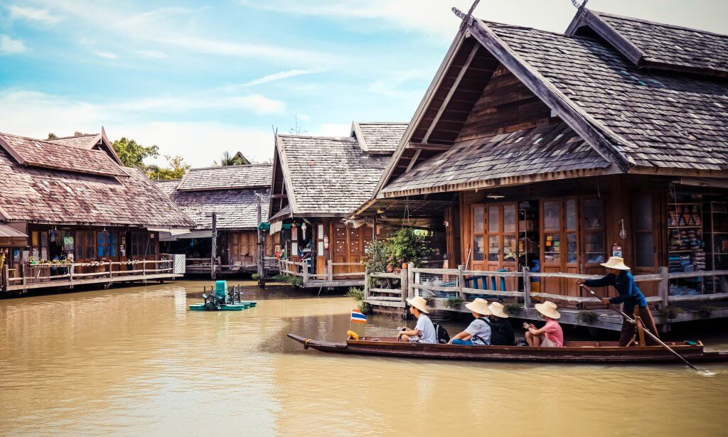 Group of people on a boat tour at a floating market in Thailand