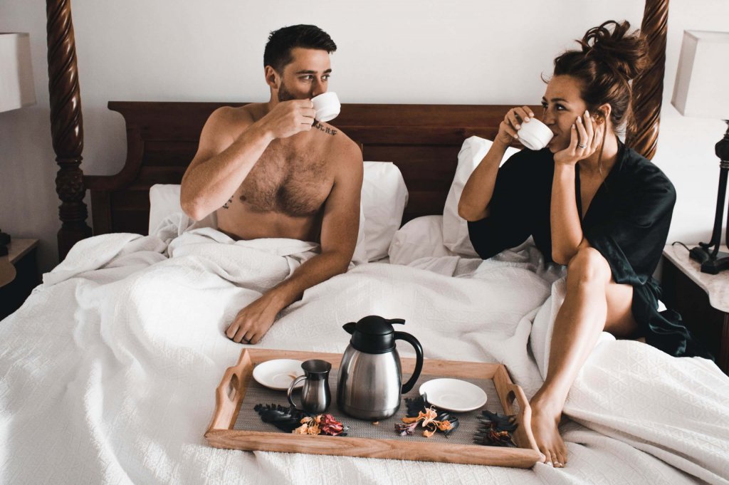 couple drinking morning coffee in a bed