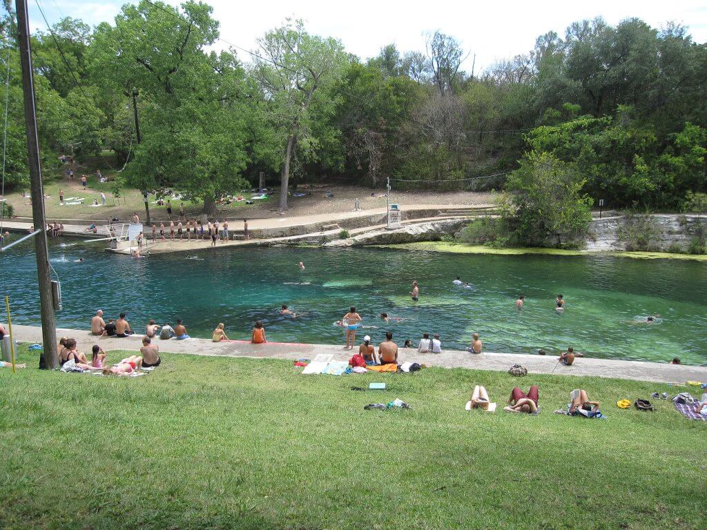 sunbathers and swimmers at Barton Springs Pool
