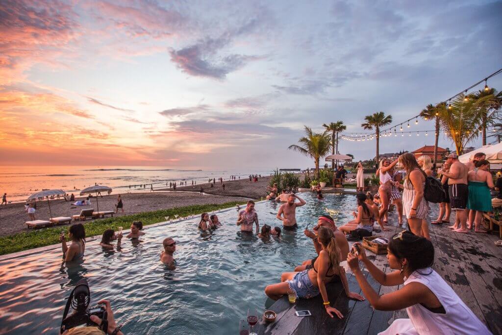 people in a beachside pool s the sunsets in canggu bali