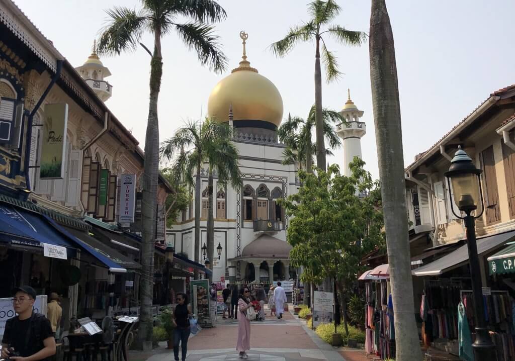 people pass in front of Sultan Mosque on Arab street in Singapore