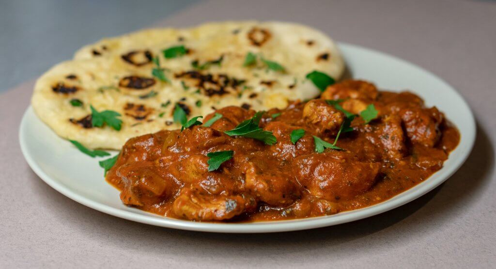 close up of a plate of Indian curry and naan