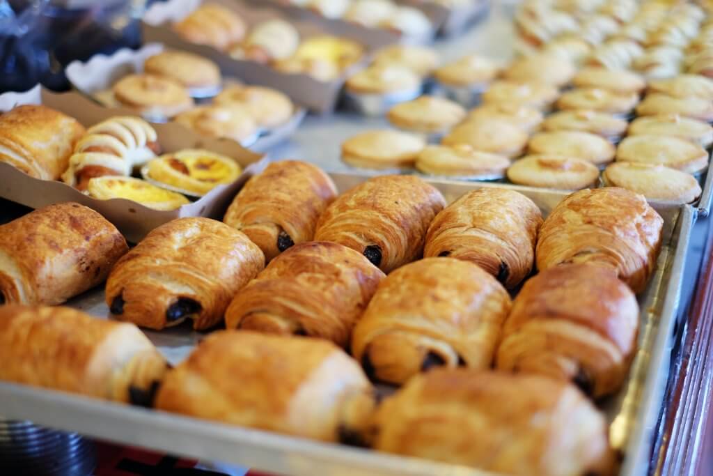 tray of pan au chocolat in a bakery display case