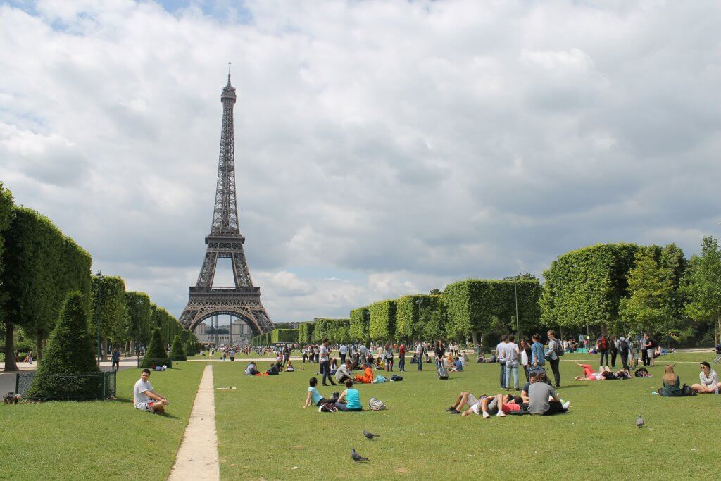 people having a picnic in paris, france with the Eiffel Tower in the background