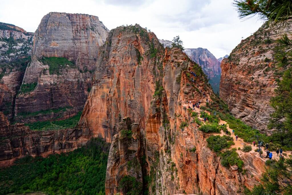 hikers traverse over the narrow trail at Angels Landing