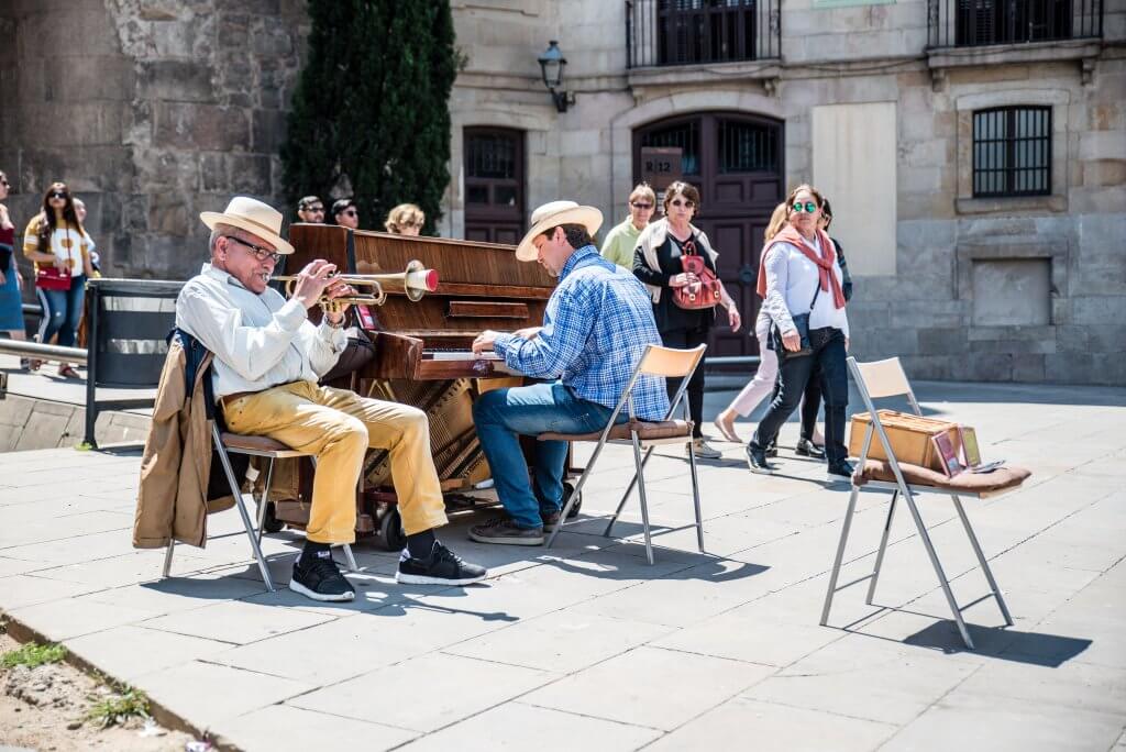 men play the piano and trumpet in the gothic quarter of Barcelona
