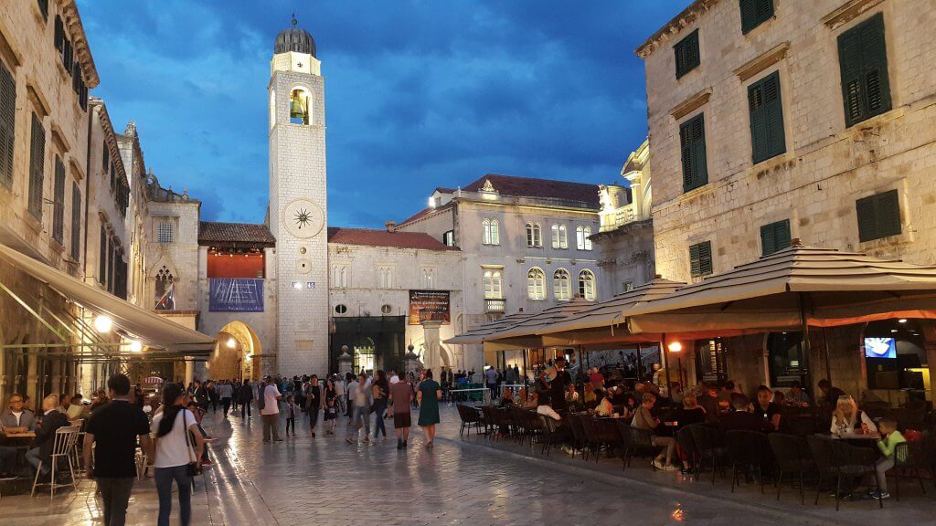 People walking through Dubrovnik's Stradun at night