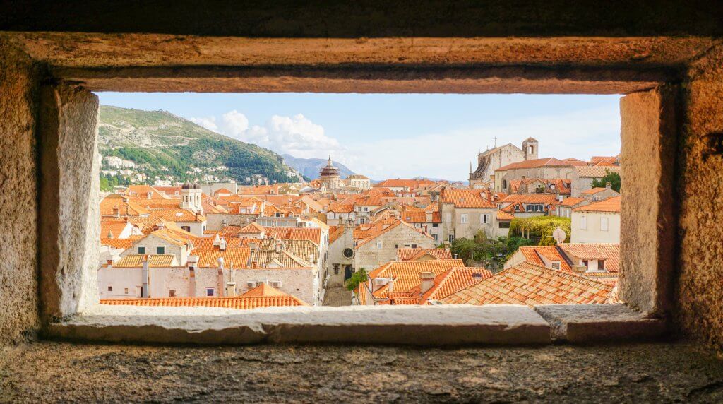 view of red tile roofs from a window along Dubrovnik's old city walls