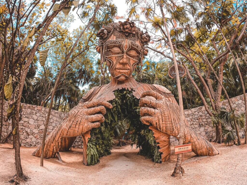 famous wooden sculpture in Tulum titled Ven a La Luz