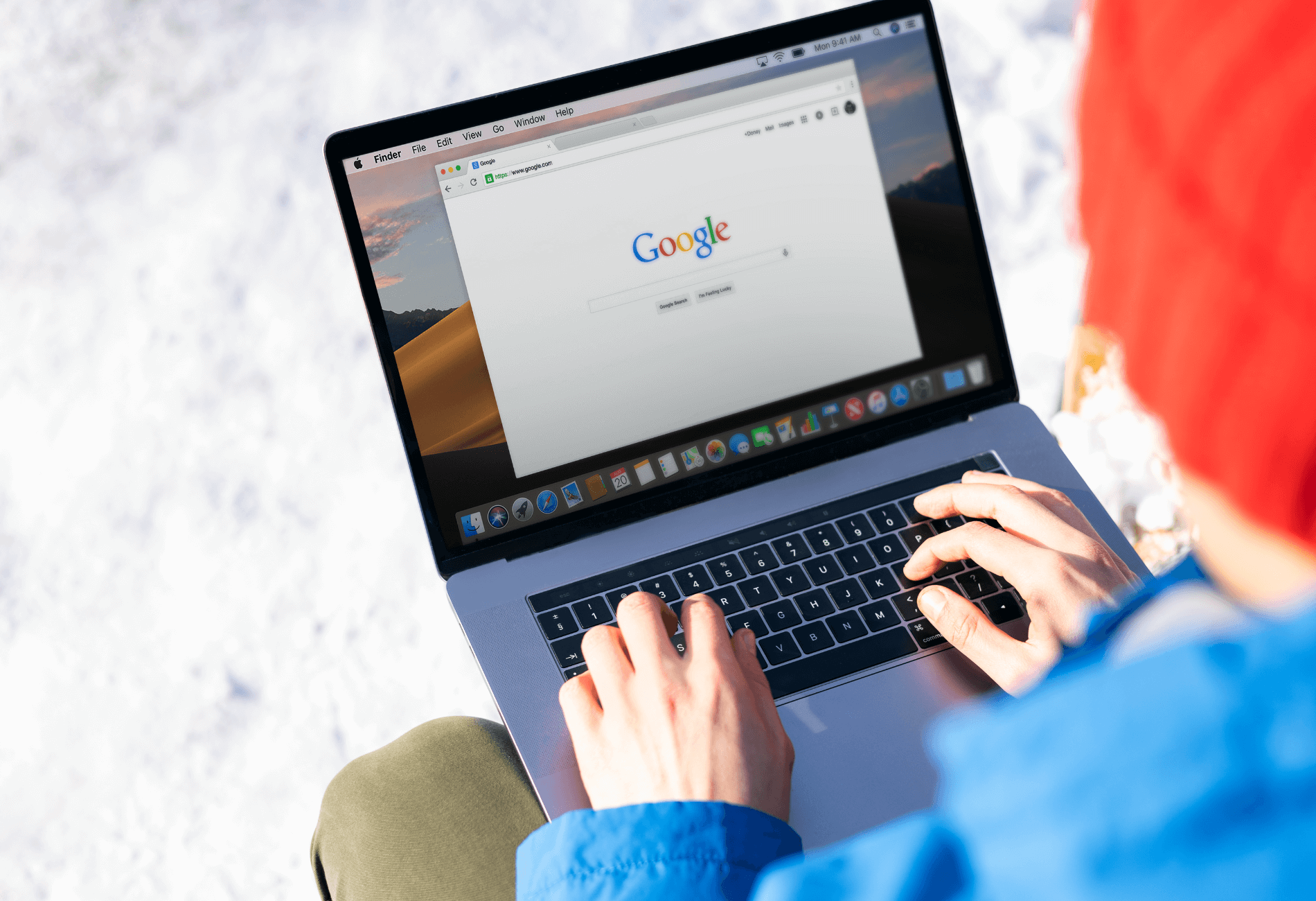 person sitting outside on their laptop looking at Google for how to use Google Flights to find cheap flights | Dollar Flight Club