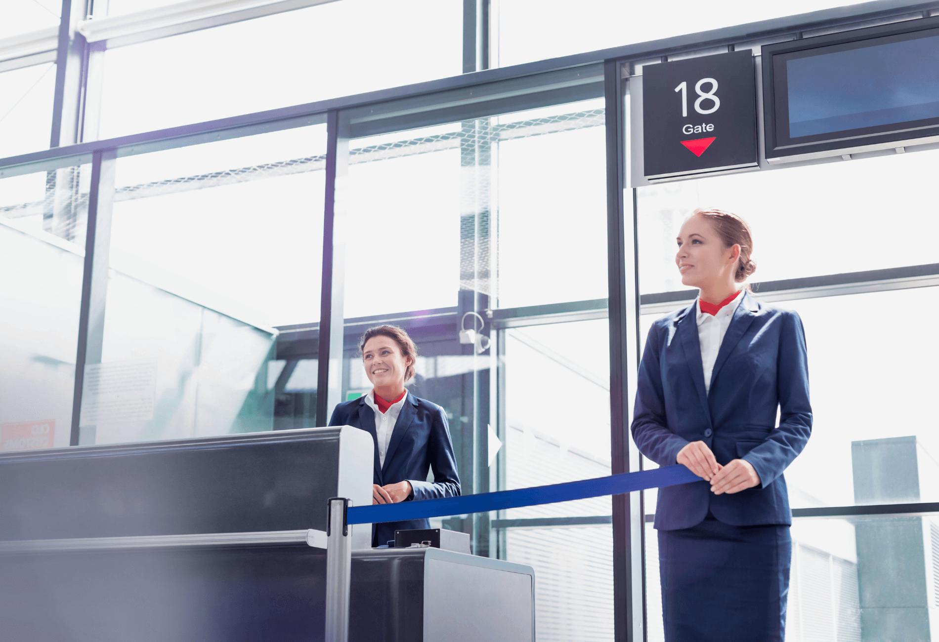 two flight attendants at gate for story on why do airlines overbook flights and how to get bumped flight compensation