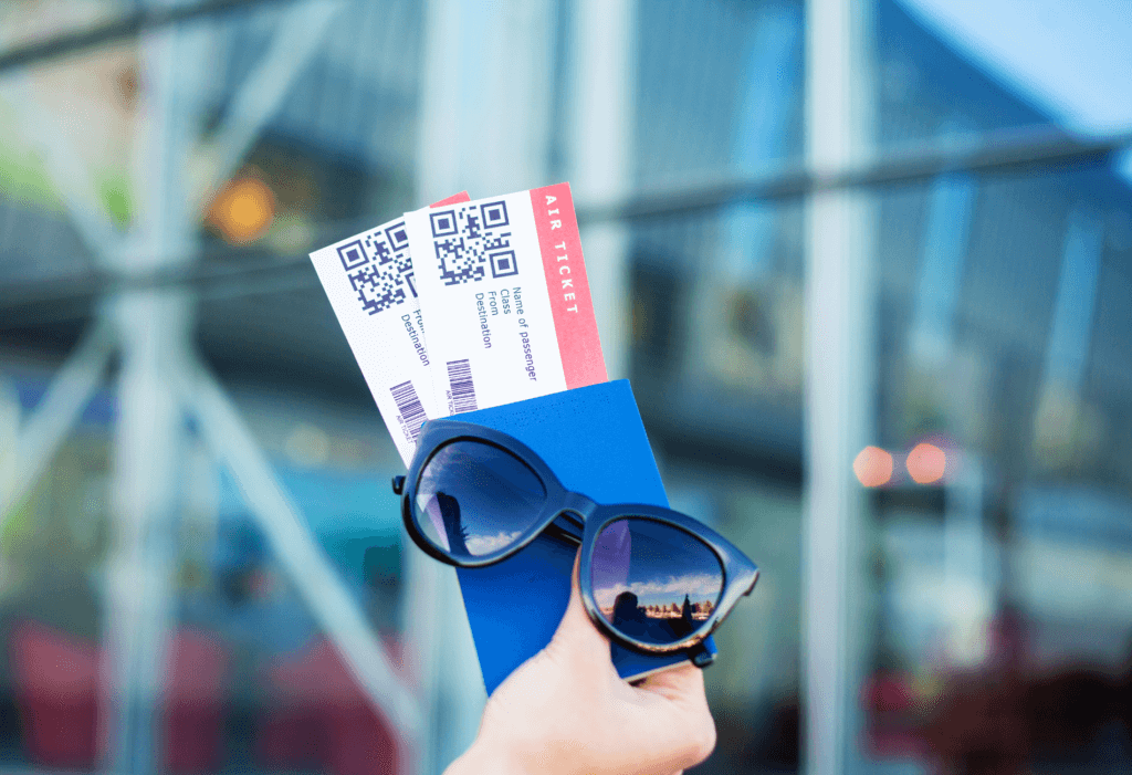 plane tickets, passport, and sunglasses for guide on how to find and book mistake fares | dollar flight club