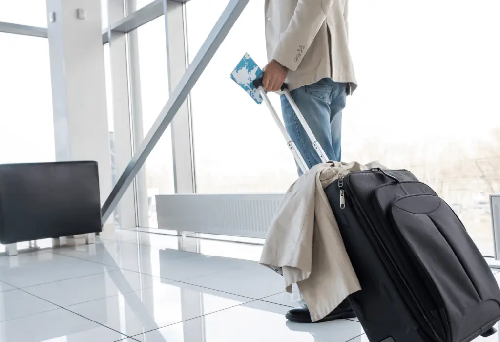 man with suitcase in airport | tips for how to pack a suitcase