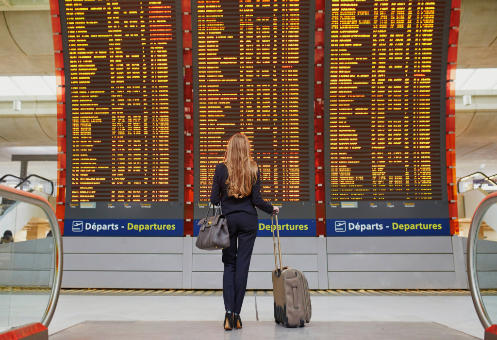 woman looking at flight information at airport