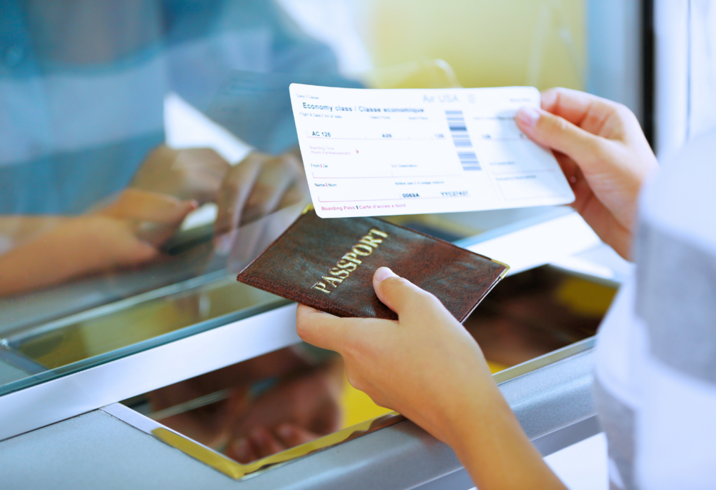 person with passport and airline ticket at airport