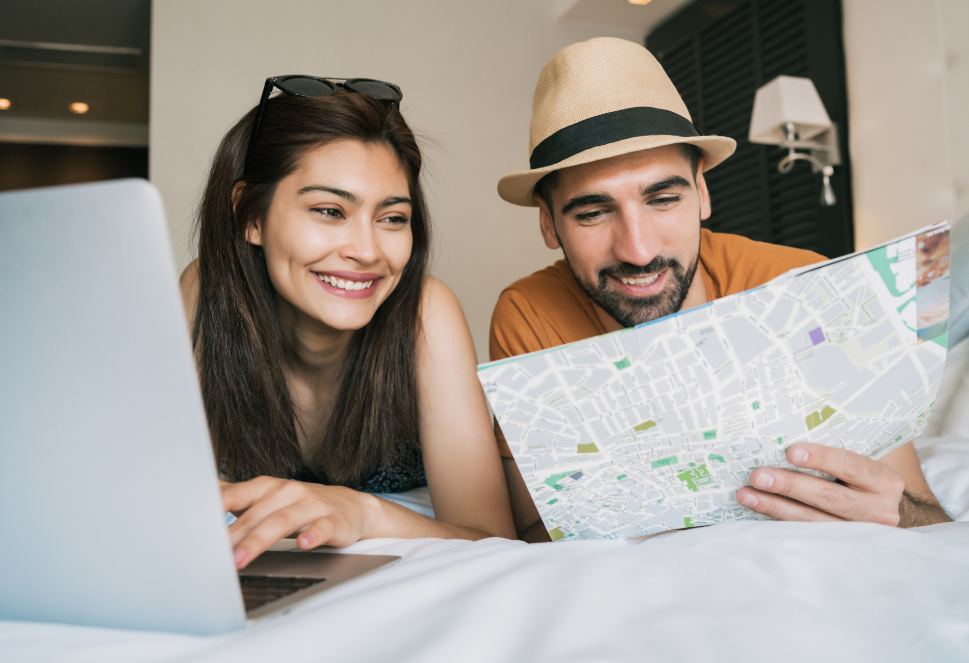 man and woman planning travel on laptop | how far in advance should you book a flight? | Dollar Flight Club