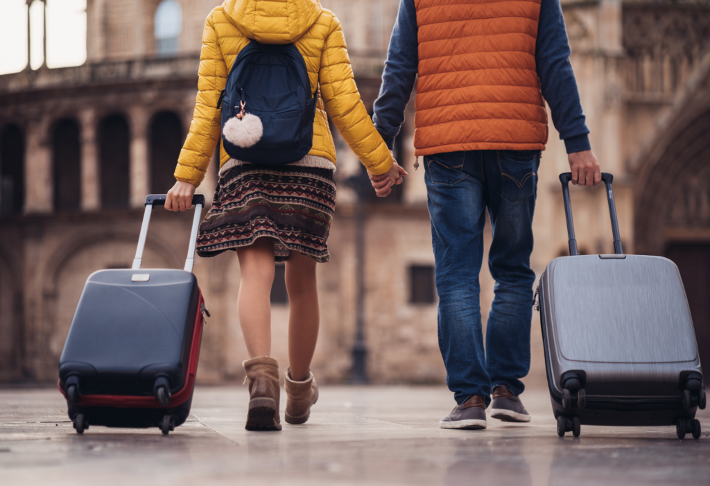 couple with luggage traveling in Europe | Is it better to buy multi-city flights or one-way